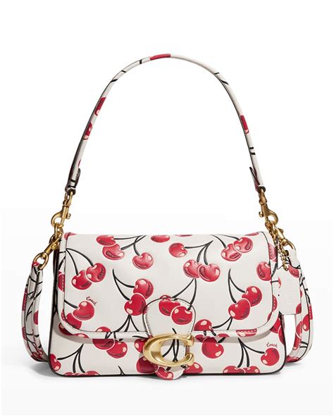 small coach bag with cherries.